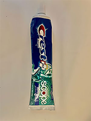 blue and green toothpaste container